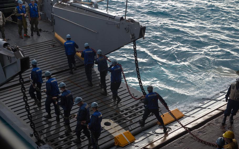 Marines and sailors embark mission equipment aboard the USS Denver at White Beach Naval Facility, Okinawa, Feb. 3, 2014. Sailors from the Denver and members of the 3rd Marine Division are heading to Thailand in support of the upcoming Exercise Cobra Gold 2014.
                