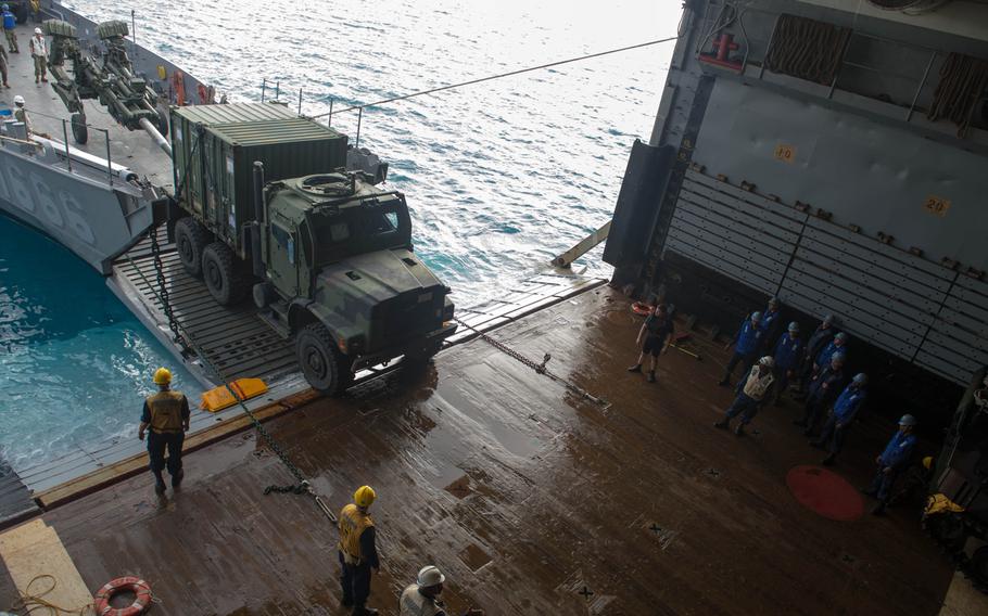 Marines and sailors embark mission equipment aboard the USS Denver at White Beach Naval Facility, Okinawa, Feb. 3, 2014. Sailors from the Denver and members of the 3rd Marine Division are heading to Thailand in support of the upcoming Exercise Cobra Gold 2014.
                