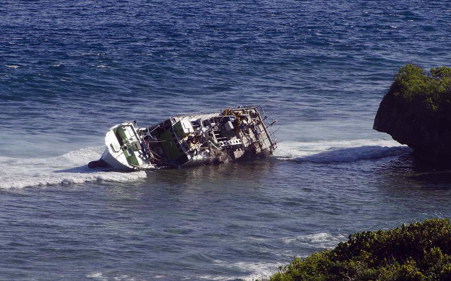 The Japanese commercial fishing vessel Daiki Maru can be seen from Orote Point on U.S. Naval Base Guam. Sailors from Helicopter Sea Combat Squadron 25 conducted a search-and-rescue operation and rescued 10 fishermen from the sinking vessel that ran aground near Spanish Steps on Feb. 13, 2014.