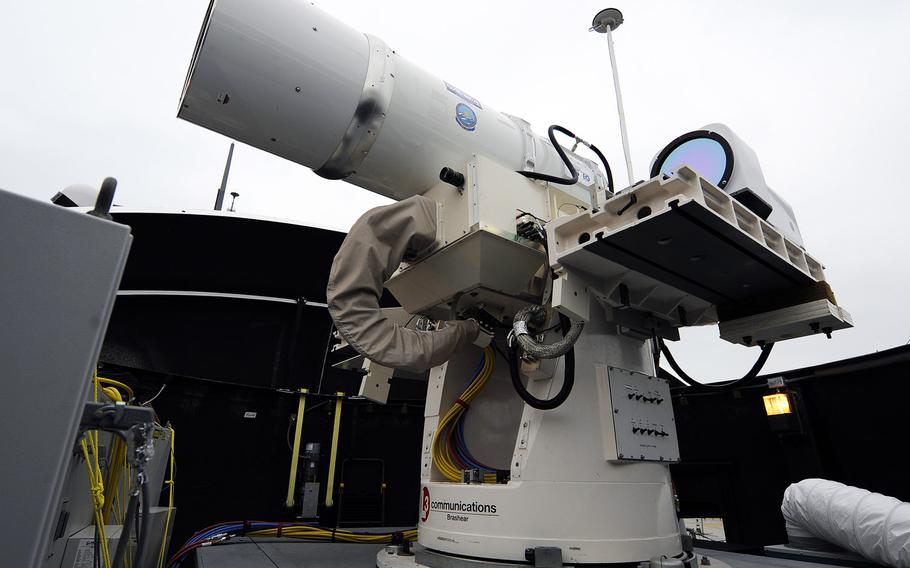 In this July 30, 2012 photo provided by the U.S. Navy, a laser weapon sits temporarily installed aboard the guided-missile destroyer USS Dewey in San Diego. The Navy plans to deploy its first laser on a ship in 2014, and intends to test an electromagnetic rail gun prototype aboard a vessel within the following two years.