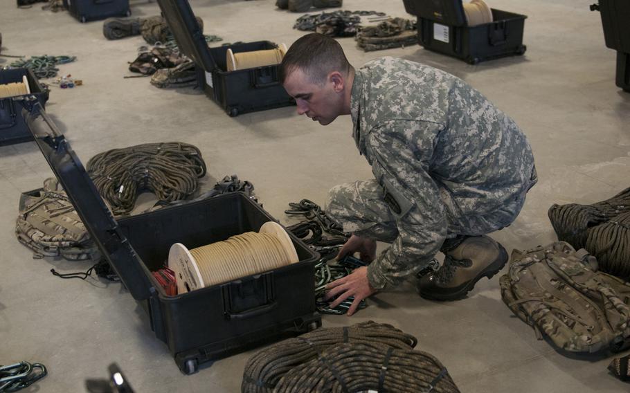 U.S. Army Staff Sgt. Bradley Cormier, a supply sergeant with the Army Mountain Warfare School inventories the newly received Army Mountaineering Kits (AMKs) at the Ethan Allen Firing Range, Jericho, Vt., on Feb. 19, 2014. The AMK which was developed to help soldiers traverse cliffs and mountain faces as well as cross snow and ice, will be fielded in four different kits tailored to meet different mission requirements.