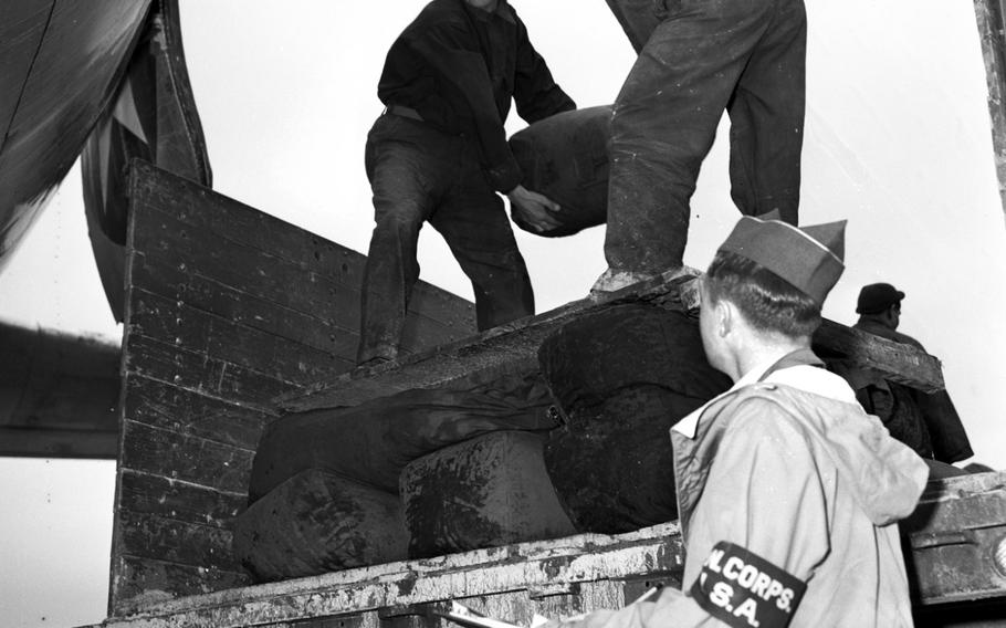 Coal is unloaded from a truck onto a Berlin-bound transport plane in July, 1948.