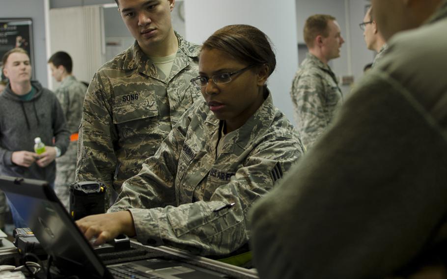 Senior Airman Fawndana Estelle-Babian, a personnelist part of Yokota Air Base's Noncombative Evacuation Office, operates the NEO Tracking System during the Samurai Readiness Inspection March 3, 2014. The evacuation simulation tested Yokota's NEO staff on proper procedure in the case of a voluntary evacuation.