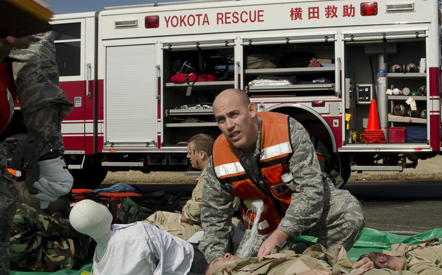 An airman from the 374th Airlift assesses simulated injuries in triage during the Samurai Readiness Inspection at Yokota Air Base March 3, 2014.