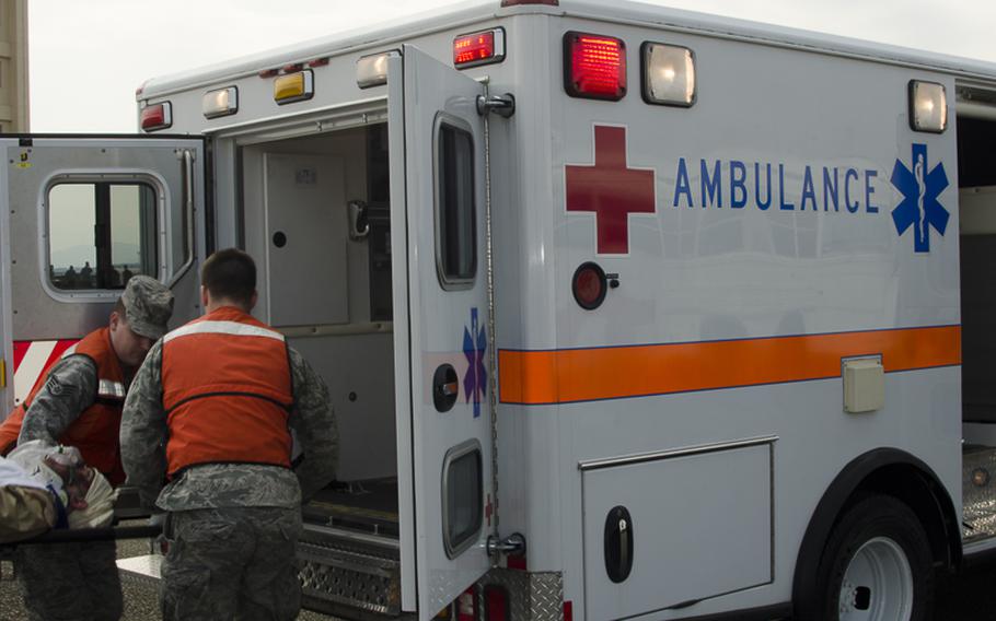 Airman from the 374th Airlift Medical Group lift another airman with simulated injuries into an ambulance during the Samurai Readiness Inspection March 3, 2014 at Yokota Air Base. 