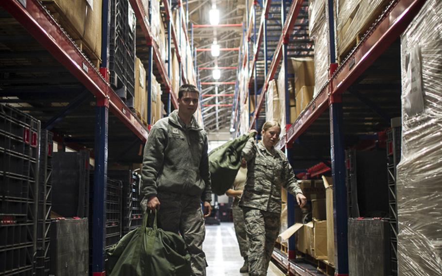 Airman 1st Class Stephen Tessier, 374th Aircraft Maintenance Squadron, and 2nd Luetent Melody Beidler, 730th Air Moblity Squadron, get their Mission Oriented Protective Posture gear in preperation for Yokotaâ€™s upcoming Samurai Readiness Inspection at Yokota Air Base, Japan, Feb. 28, 2014. The MOPP gear used to protect members in hazardous environments, such as during a chemical, biological, radiological, or nuclear attack. 
