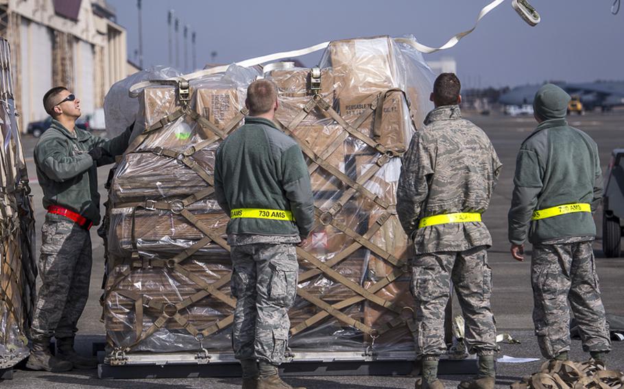 Airmen from the 730th Air Mobility Squadron prepare cargo for deployment during a Samurai Readiness Inspection at Yokota Air base, Japan, March 4, 2014. The inspection was designed to evaluate Yokota's ability to perform provide airlift capabilities through a variety of contingency response scenarios. 