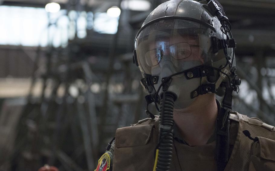 An airman dons his aircrew chemical defense ensemble during the Samurai Readiness Inspection week, ensuring the base is ready to defend and deter enemy aggresion.
