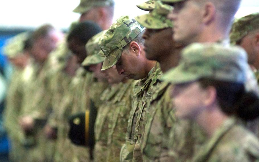 Second Cavalry Regiment soldiers say a quick prayer upon returning home safely to Vilseck, Germany, from their most recent deployment to Afghanistan, Monday, April 7, 2014.