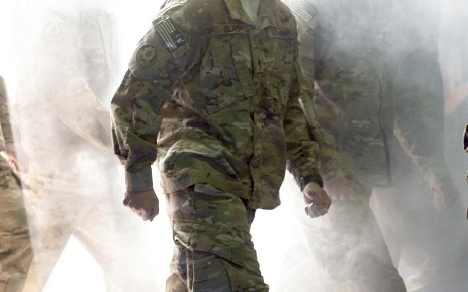 The 2nd Cavalry Regiment Dragoons make a dramatic entrance upon their return from their deployment to Afghanistan on Monday, April 7, 2014.