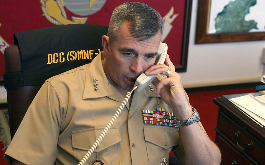Lt. Gen. John Wissler, the commanding general of III Marine Expeditionary Force, speaks on the telephone from an office at Camp Courtney, Okinawa, on Dec. 6, 2013.