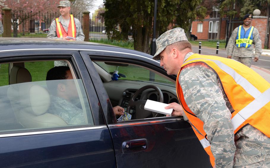 Col. David Cox, 100th Air Refueling Wing vice commander, passed out information about safe driving to personnel leaving the base on Thursday, April 3, 2014, before the start of a three-day weekend. Someone from the base was charged with driving under the influence two days later.
                