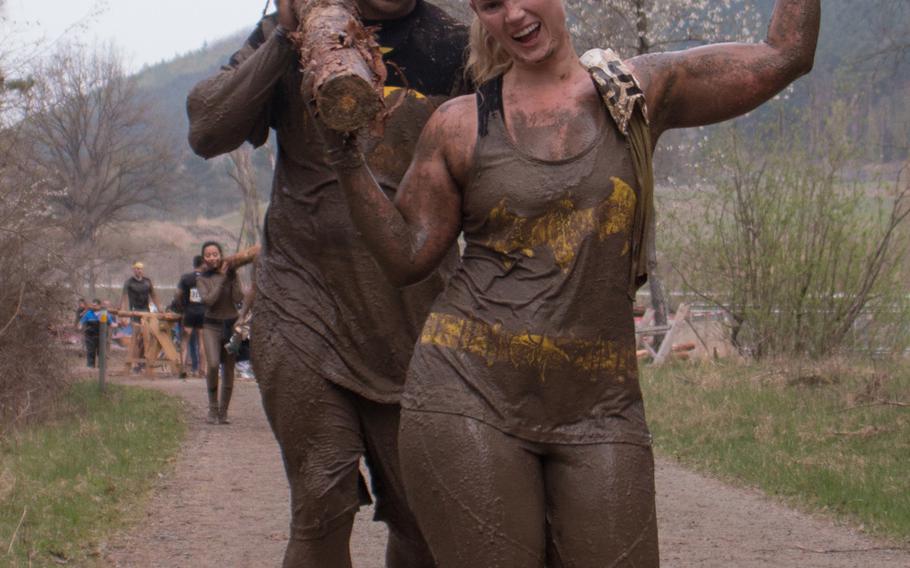 Teammates pick up freshly-sawed logs for a lengthy run as part of the Grafenwöhr Rugged Terrain Obstacle Course, April 12, 2014. 