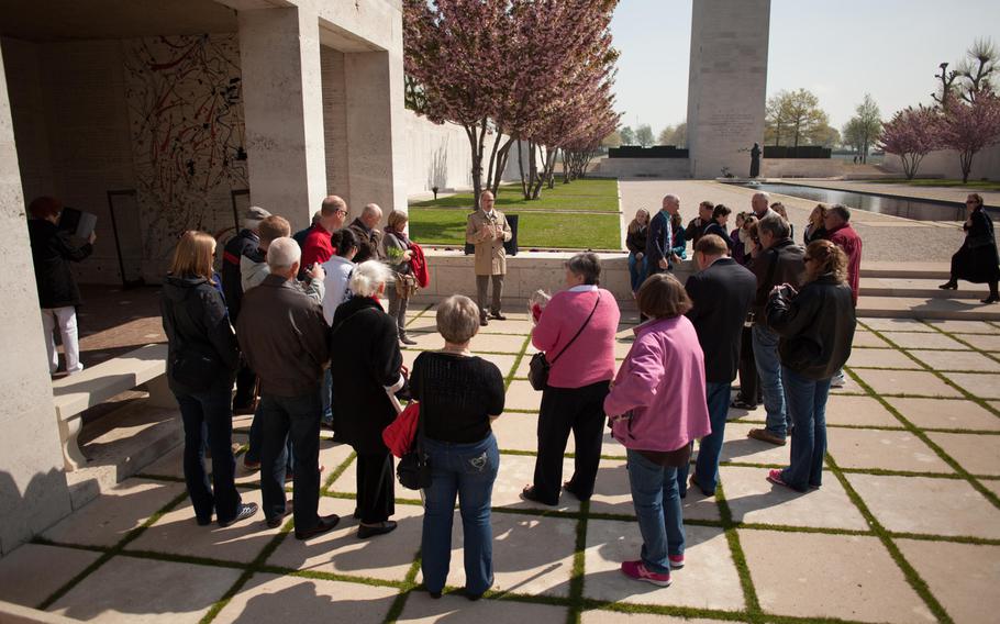 Richard Arsenault, assistant superintendent of the Netherlands American Cemetery and Memorial in Margraten, Netherlands, talks with relatives of World War II veterans who came to visit the graves of the six men who died when their plane was shot down over Belgium on April 13, 1944.