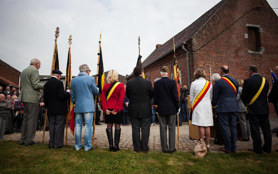 Belgian dignitaries and former members of the Belgian resistance from World War II stand during a ceremony in Fouleng, Belgium, honoring the crew of an American B-17 bomber that crashed here on April 13, 1944. Four crew members bailed out and survived; six others died.