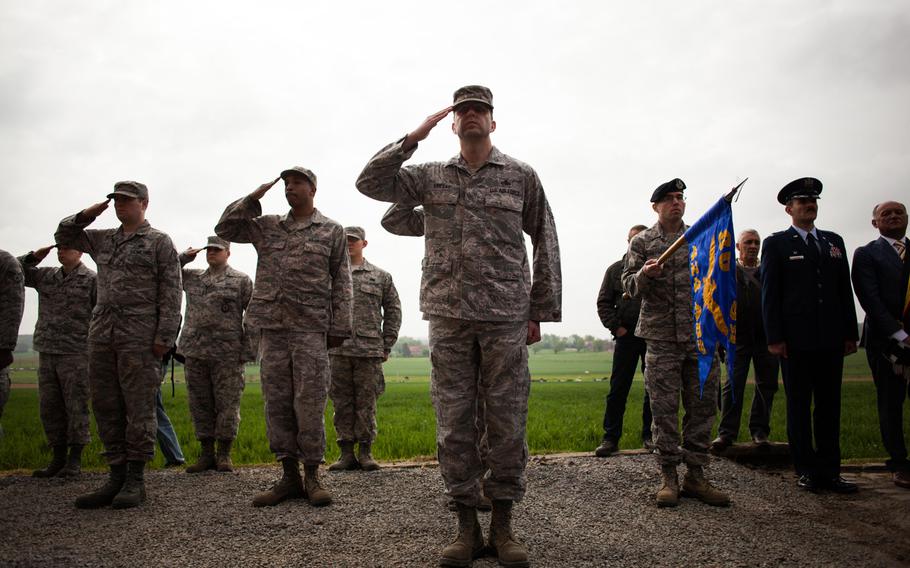 U.S. airmen from Chievres Air Base in Belgium render honors during a ceremony commemorating the 70th anniversary of an American B-17 bomber crash in Fouleng, Belgium. Four crewmen bailed out of the plane after it was hit by German flak guns; six others died when the plane crashed into the field behind the airmen.