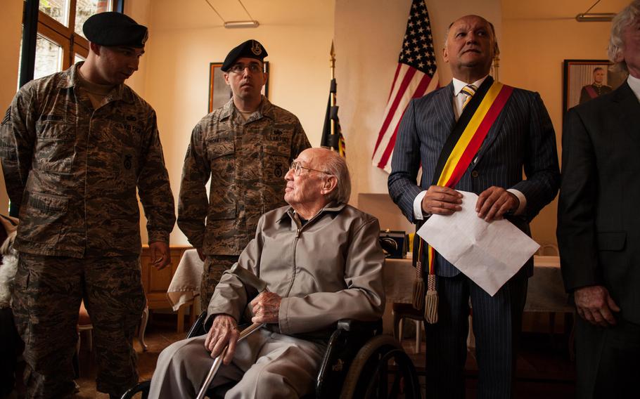 Troy Hollar, center, speaks with an American airmen moments before he is granted honorary citizenship in the village of Silly (Fouleng), Belgium, where his B-17 bomber crashed in World War II. Hollar and three others survived, bailing out before the plane hit the ground.