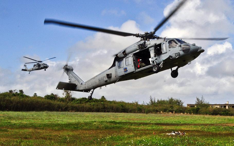 An MH-60S Seahawk from Helicopter Sea Combat Squadron 25 performs maneuvers during a training event with the Guam Army National Guard at Andersen South, Guam, on Feb. 19, 2013. An HSCS-25 crew helped rescue a woman and her daughter lost in a Guam jungle on Thursday, April 17, 2014.