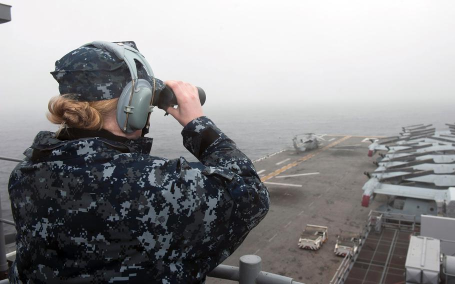 Seaman Ashlee Stone scans the horizon from the forward lookout of the USS Bonhomme Richard. Sailors and Marines aboard the amphibious assault ship are conducting search and rescue operations as requested by the Republic of Korea navy near the scene of the sunken ferry Sewol in the vicinity of the island of Jindo.