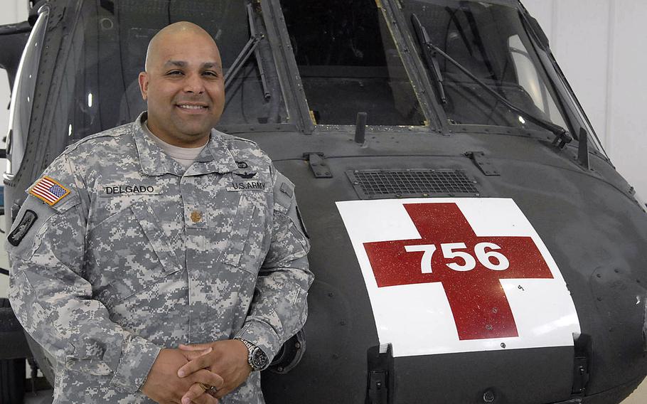 Army Maj. Jesse Delgado, commander of Company C, 1st Battalion, 214th Aviation Regiment, stands in front of a Blackhawk at the company's headquarters at the Landstuhl Army Heliport in Germany on Wednesday, April 30, 2014. The company bid farewell Wednesday morning to nearly 40 of its soldiers, who are deploying to Kuwait. After 52 years at Landstuhl, the unit is also preparing to relocate to Grafenwoehr, Germany.