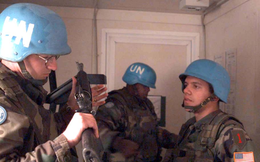 Sgt. Michael Wolfe inspects the rifle of Pvt. 2 Jeffery Barnaby before going on a patrol in northern Macedonia in March, 1998. In the background is Spec. Jerry Jordan. The infantryman, based in Schweinfurt, Germany, are part of the United Nations peacekeeping force in Macedonia.