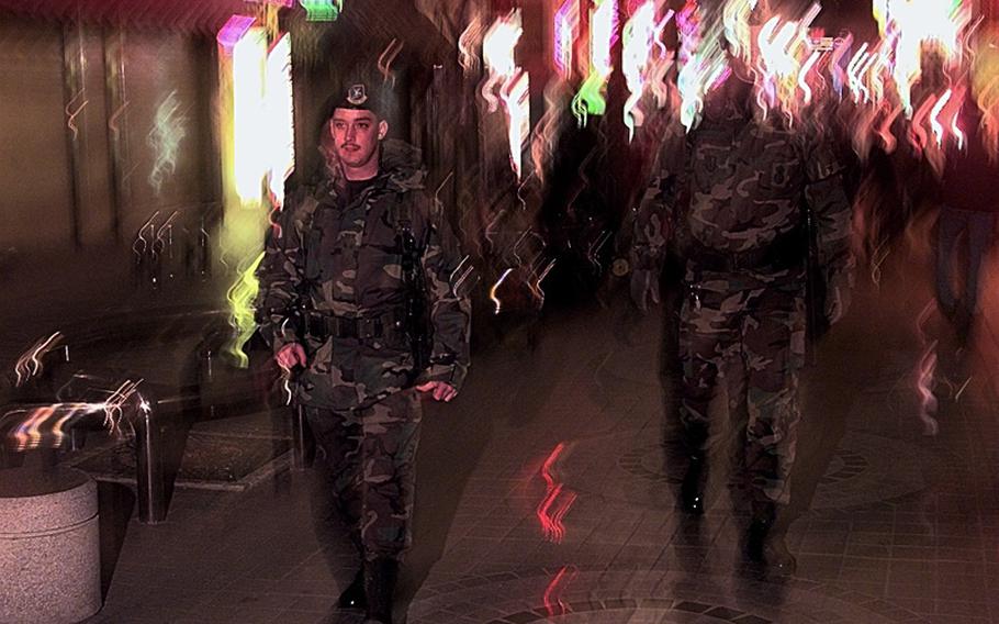 Airmen from the 51st Security Forces Squadron, Osan Air Base, Republic of Korea, patrol the streets outside the base's gates in this file photo from Oct, 31, 1998.