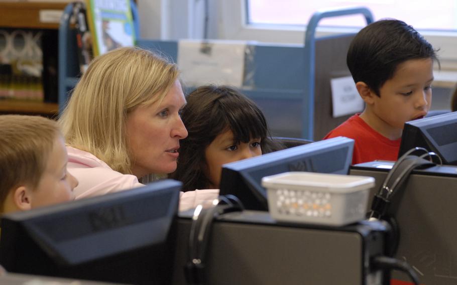Sarah Loomis helps Kaiserslautern Elementary School kindergarten students with a computer project Thursday, June 5, 2014. Loomis, the school's educational technologist, will compete for national teacher of the year after being named the Department of Defense Education Activity's teacher of the year.