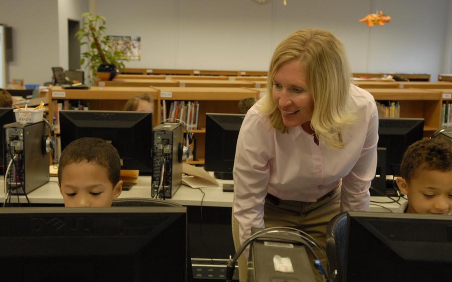 Sarah Loomis helps Kaiserslautern Elementary School kindergarten students Sean Simpkins, left, and Kristopher Lewis with a computer project Thursday, June 5, 2014. This school year, Loomis, named the Department of Defense Education Activity's teacher of the year, introduced computer coding, inspired by the “Hour of Code,” a nationwide campaign asking schools, teachers and parents to help introduce students to computer programming.
