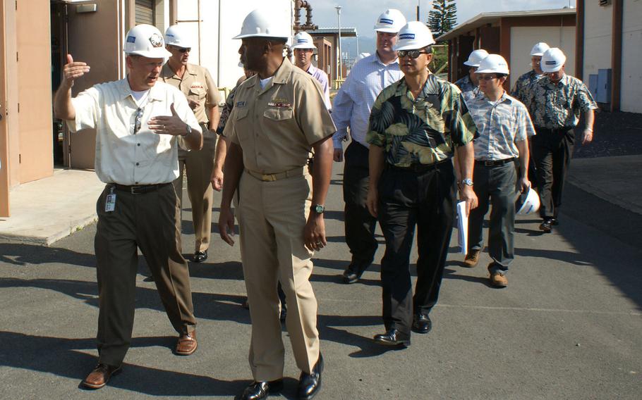 Rear Adm. Frank Ponds, the former commander of Navy Region Hawaii, center, listens to an explanation of the Smart Power Infrastructure Demonstration for Energy Reliability and Security at Joint Base Pearl Harbor-Hickam in this January 2013 photo. Hickam was the first of three bases used for the SPIDERS demonstration project, which is now culminating at Marine Corps Camp Smith, where an electric microgrid is expected to be completed by the spring of 2015.