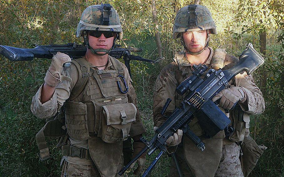 Lance Cpls. Kyle Carpenter, left. and Nicholas Eufrazio carry their weapons in Marjah, Afghanistan, during their 2010 deployment. On June 19, 2014, President Barack Obama will award Carpenter, now medically retired, the Medal of Honor for conspicuous gallantry.