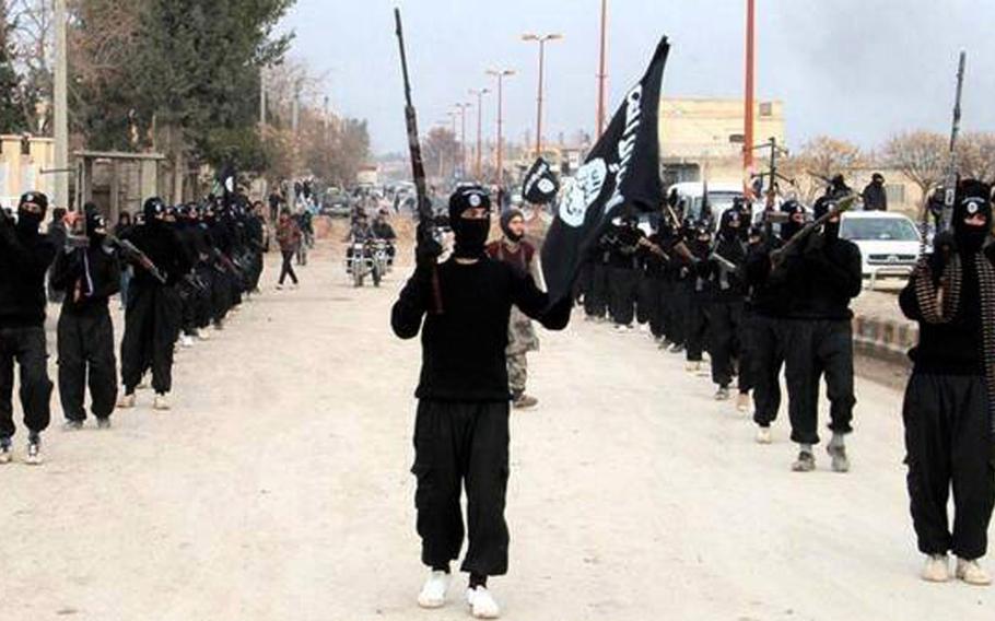 This undated file image posted on a militant website on Tuesday, Jan. 14, 2014, which has been verified and is consistent with other AP reporting, shows fighters from the al-Qaida linked Islamic State of Iraq and the Levant (ISIL) marching in Raqqa, Syria.