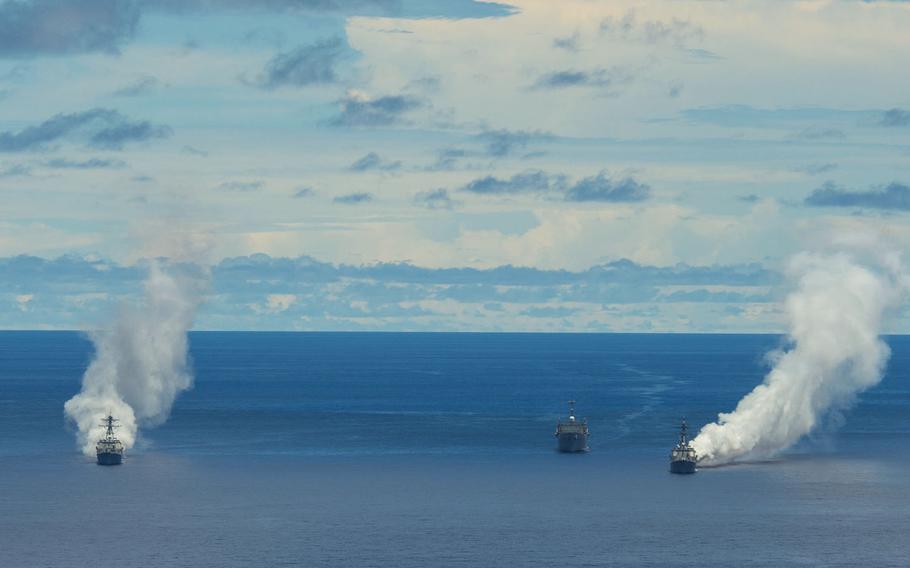 USS Mustin, USS Wayne E. Meyer and USS Frank Cable test a carbon fiber-based obscurant fog south of Guam to assess their tactical effectiveness for anti-ship missile defense.