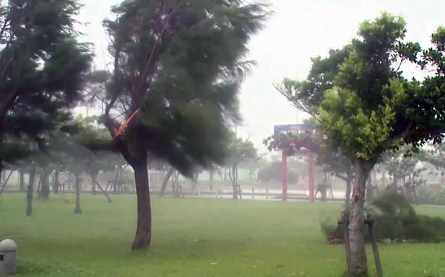 Video screen grabs show scenes of Typhoon Neoguri slamming into Okinawa.