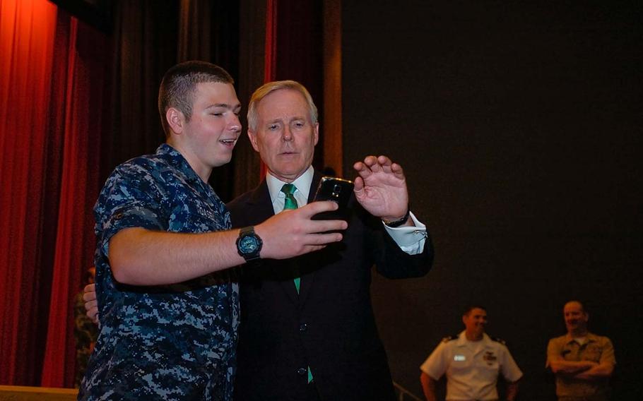 Ray Mabus, secretary of the Navy, takes a 'selfie' photograph with a sailor after an all-hands meeting at Yokosuka Naval Base's Fleet Theater on July 28, 2014.