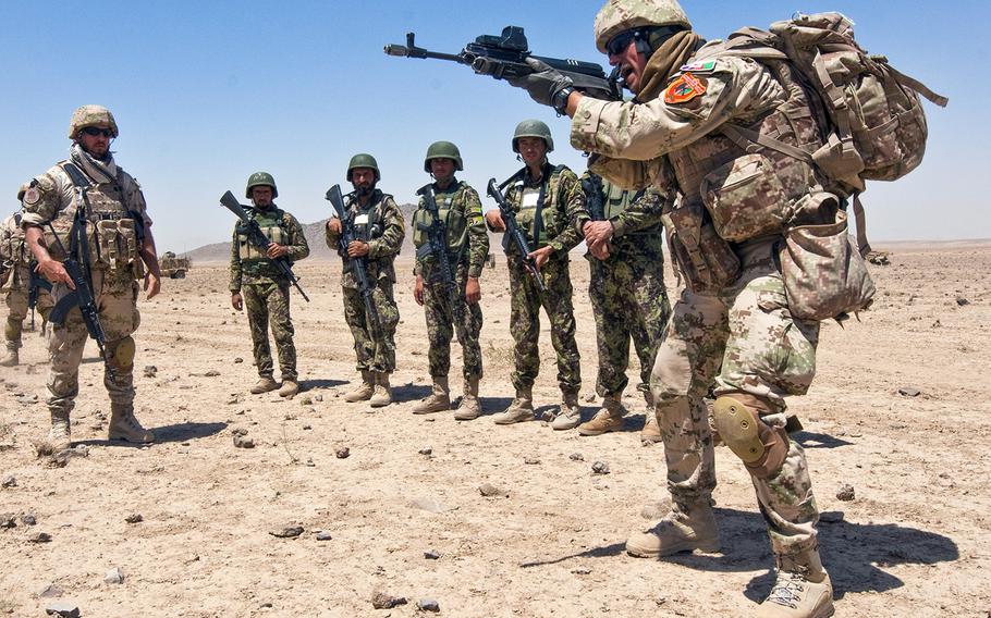 Slovak Staff Sgt. Peter Sulgan, right, teaches an upright shooting posture to Afghan soldiers with the 4th Kandak, 2nd Mobile Strike Force Brigade, Afghan National Army, while Slovakian Capt. Lubomir Januska observes. Both Sulgan and Januska serve on a Slovak Security Force Advisory Team, Regional Command-South, who train Afghan soldiers to become weapons instructors within their own ranks to make the ANA a more self-sustained force.
