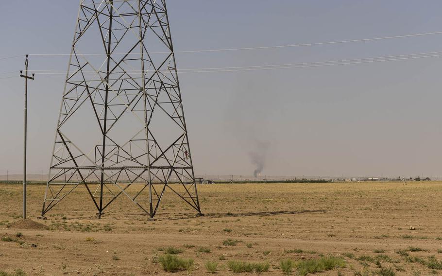 Tongues of orange fire flare from drill sites on the horizon south of Irbi, capital of Iraqi Kurdistanl.
                