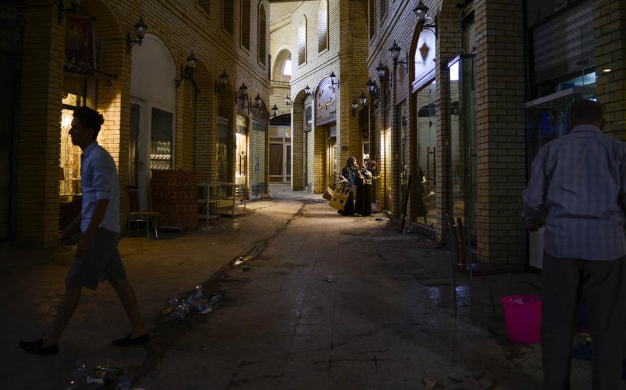 A handful of shoppers patronize the few open shops in the souq, a traditional market, located at the base of the Irbil Citadel in the center of the capital of Iraqi Kurdistan, Friday, Aug. 22, 2014.
                