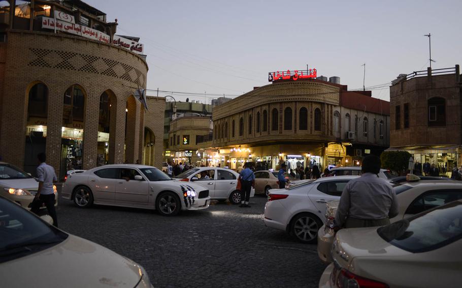 The lively evening traffic outside the souq, a traditional market, in the center of Irbil, Aug. 25, 2014.
                