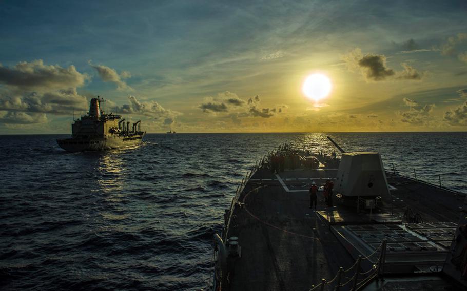 The Arleigh Burke-class guided-missile destroyer USS Mustin maneuvers alongside the Lewis and Clark-class dry cargo ship USNS Pecos to conduct a replenishment-at-sea during Valiant Shield 2014.