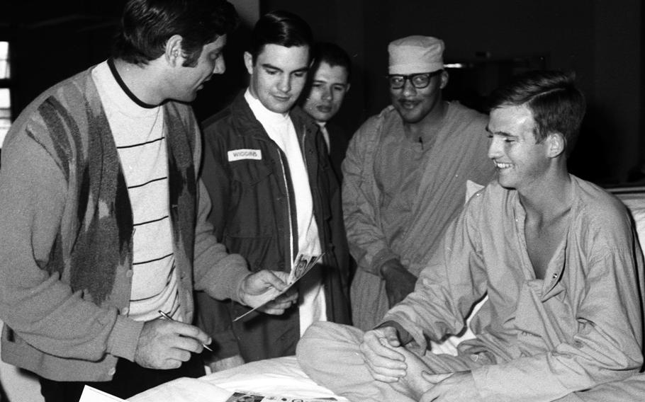 Joe Namath signs an autograph for Pfc. Henry Lock at the U.S. Army Hospital on Camp Oji, Japan, in January, 1969.