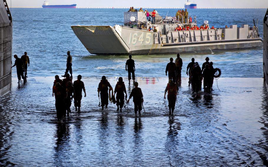 A landing craft utility departs the amphibious assault ship USS Kearsarge as sailors return to the ship's well deck on Sept. 19, 2014. Lengthy deployments and a risk-averse service culture are among the frustrations sailors face in the Navy, according to an independent survey led by a Navy pilot.