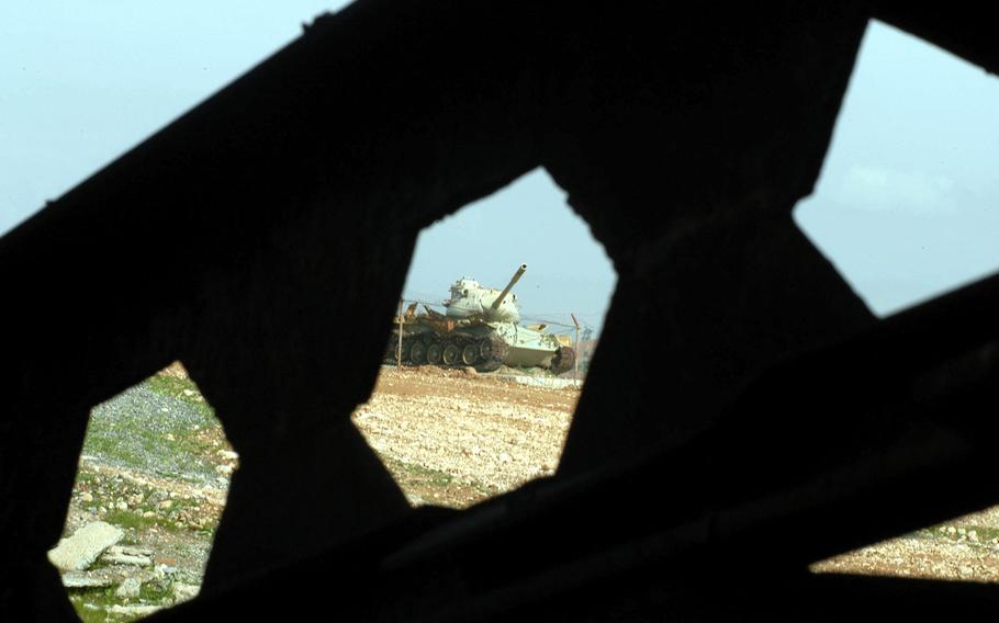 Rusting milary tanks left from the Iraq-Iran war are scattered across the countryside near Qasr-e-Shirin, Iran, in 2003. A New York Times investigation found U.S. and Iraqi soldiers from the Iraq War had been injured by Iraq chemical weapons left over from the Iran-Iraq War in the 1980s.