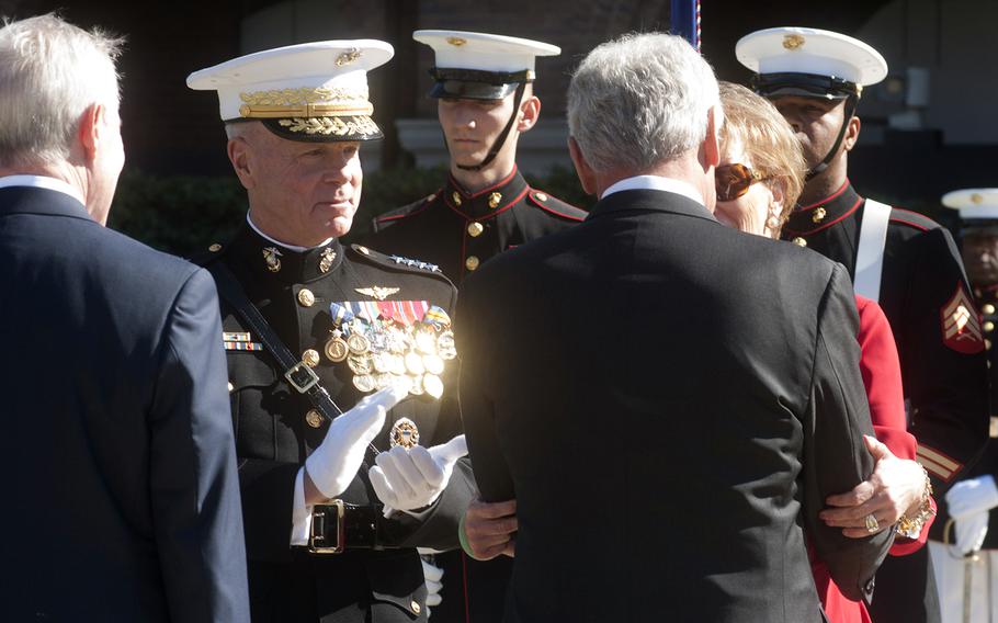 General Amos claps as Secretary of Defense Chuck Hagel thanks Amos' wife for her dedication to the military during the Passage of Command ceremony at the Marine Barracks in Washington, D.C., on Oct. 17, 2014.