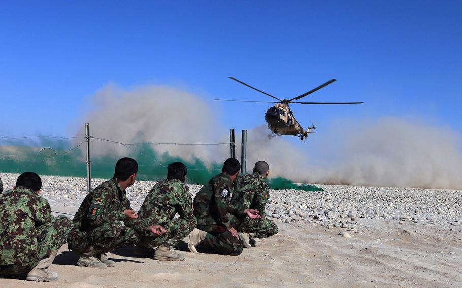 Students in the Afghan Tactical Air Coordinator course wait to board a Mi-17 helicopter during the culminating event aboard Camp Shorabak, Helmand province, Afghanistan, Oct. 2, 2014. The weeklong course was designed to familiarize the soldiers with map reading and coordinating with airborne pilots on friendly and enemy troop positions on the battlefield.