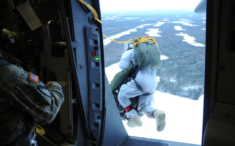 Staff Sgt. David Arcos leaps from a C-17 Globemaster III flying over Fort Greely, Alaska, during the Spartan Pegasus airborne operation Oct. 23, 2014. Spartan Pegasus is integrated with Exercise Vigilant Shield 15, an annual North American Aerospace Defense Command and U.S. Northern Command homeland defense exercise.