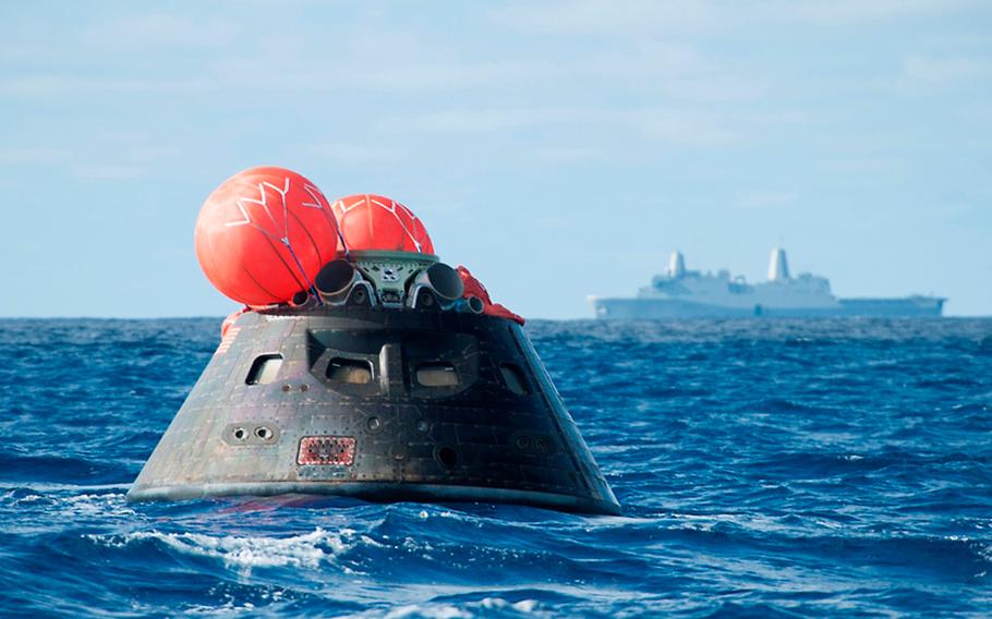 NASA's Orion spacecraft awaits the U.S. Navy's USS Anchorage in the Pacific Ocean after splashing down during a test flight Friday, Dec. 5, 2014. The Anchorage transported it to Naval Base San Diego.