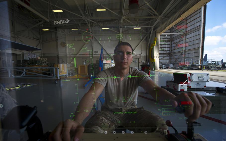 An Airman from Cannon Air Force Base sits at the control module of an MQ-9 Reaper at Hurlburt Field, Fla., April 23, 2014.
