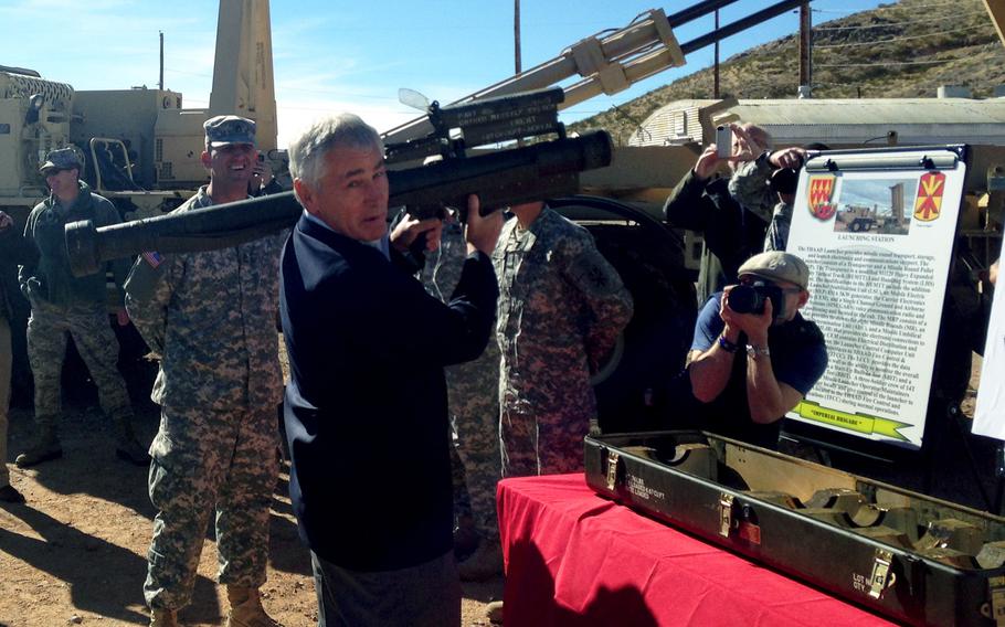 Secretary of Defense Chuck Hagel holds a "REDEYE" shoulder-fired missile launcher, at White Sands Missile Range, N.M.