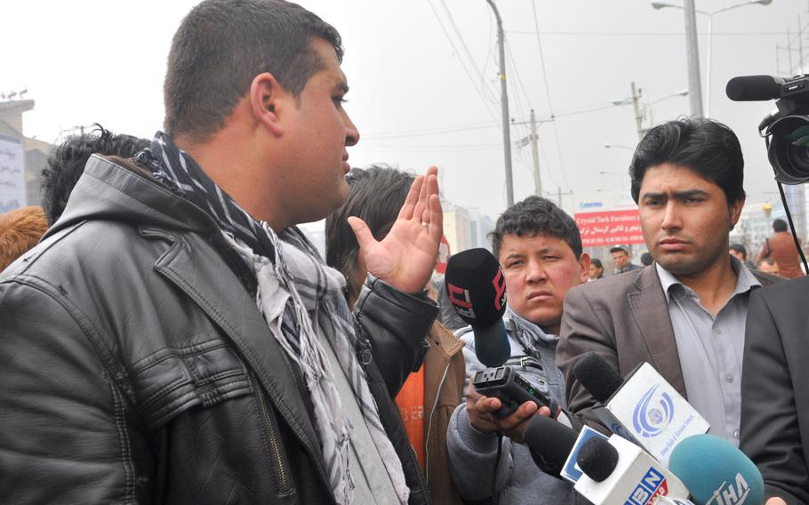 At the scene of a bombing in front of a Kabul cultural center on Thursday, Feb. 20, 2014, Afghan journalists huddled around eyewitnesses. A Human Rights Watch report released Tuesday, Jan. 20, 2015, said journalists increasingly face threats from Taliban insurgents and corrupt government officials. 
                