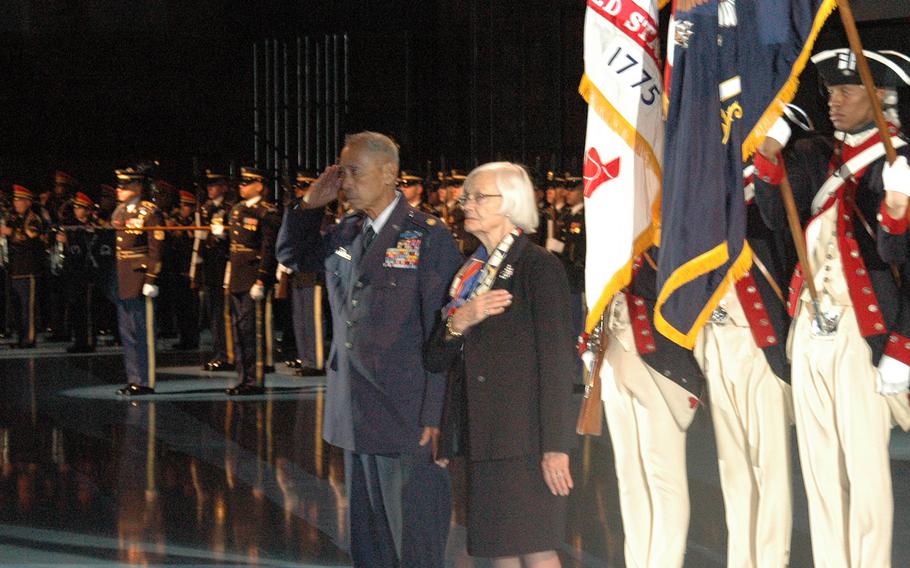 World War II veteran Jesse Baltazar salutes, as his wife, Margrit, stands beside him during a ceremony at Joint Base Myer-Henderson Hall, Va., where he received the Purple Heart from Army chief of staff Gen. Ray Odierno on Tuesday, Jan. 20, 2015.